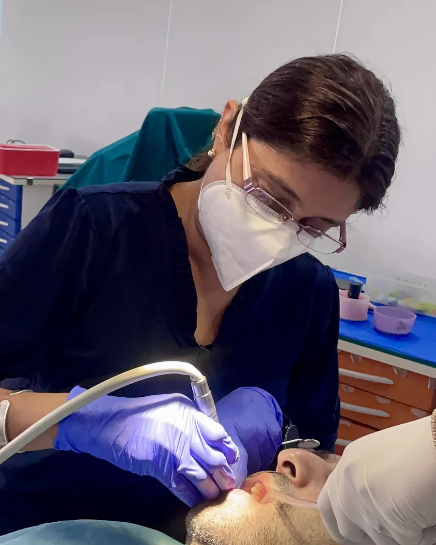 Dr. Puja Bansal examining a patient during a dental check-up