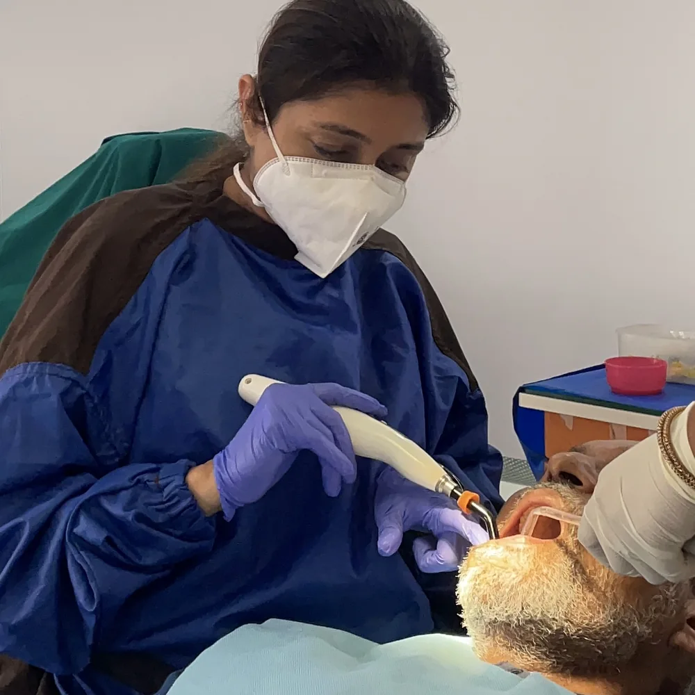Dr. Puja Bansal at work with modern dental equipment